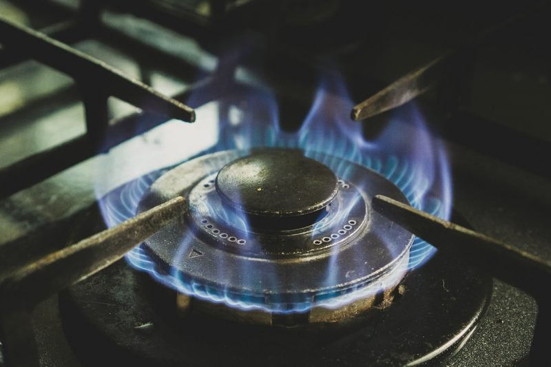 Blue flame under a cast iron burner grate